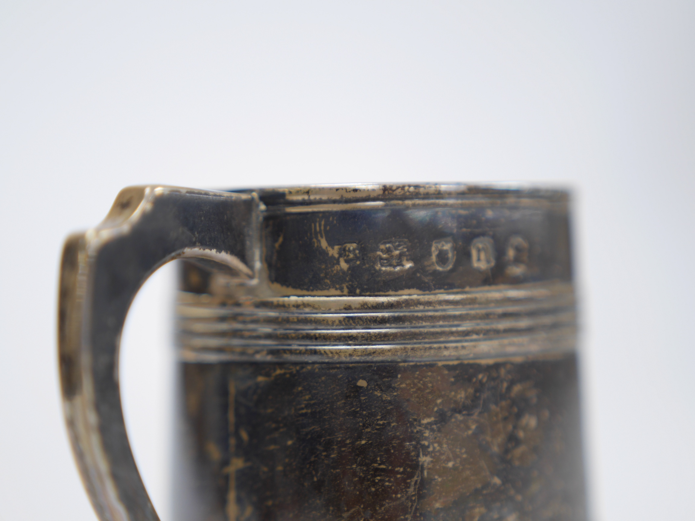 A small George III reeded silver christening mug, Walter Brind, London, 1788, 67mm, 109 grams. Condition - poor to fair